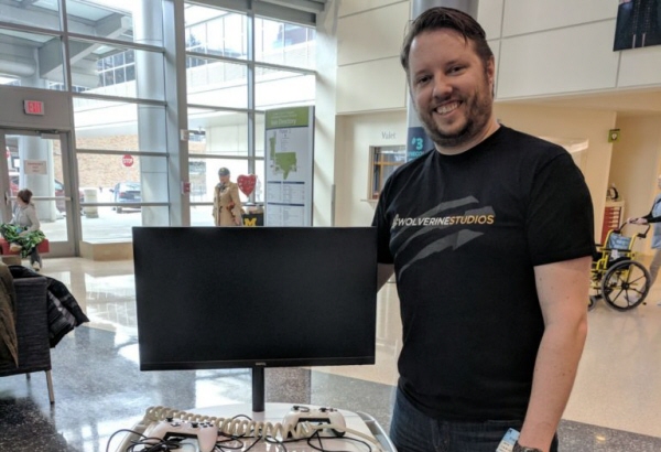 Gary Gorski, Wolverine Studios' Owner, and the Gamers Outreach game cart that was donated by the studio.