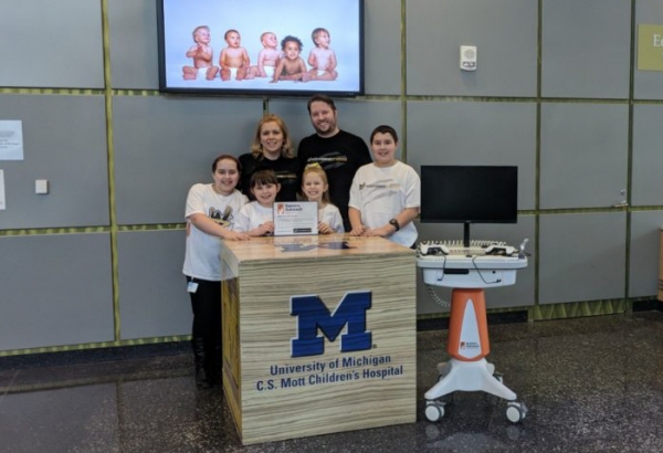 Ortonville's Gorski family at CS Mott Childrens' Hospital with the donated gaming cart.