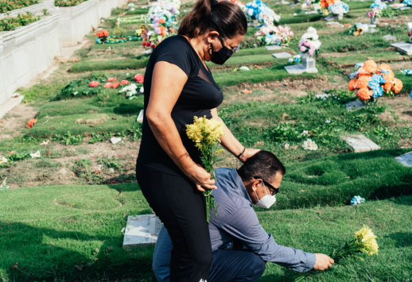 Latin couple visiting cemetery