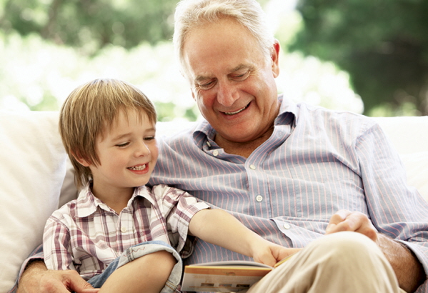 Grandfather reading with grandson